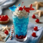Bright blue gummy sharks drink topped with whipped cream, maraschino cherries, and a candy shark